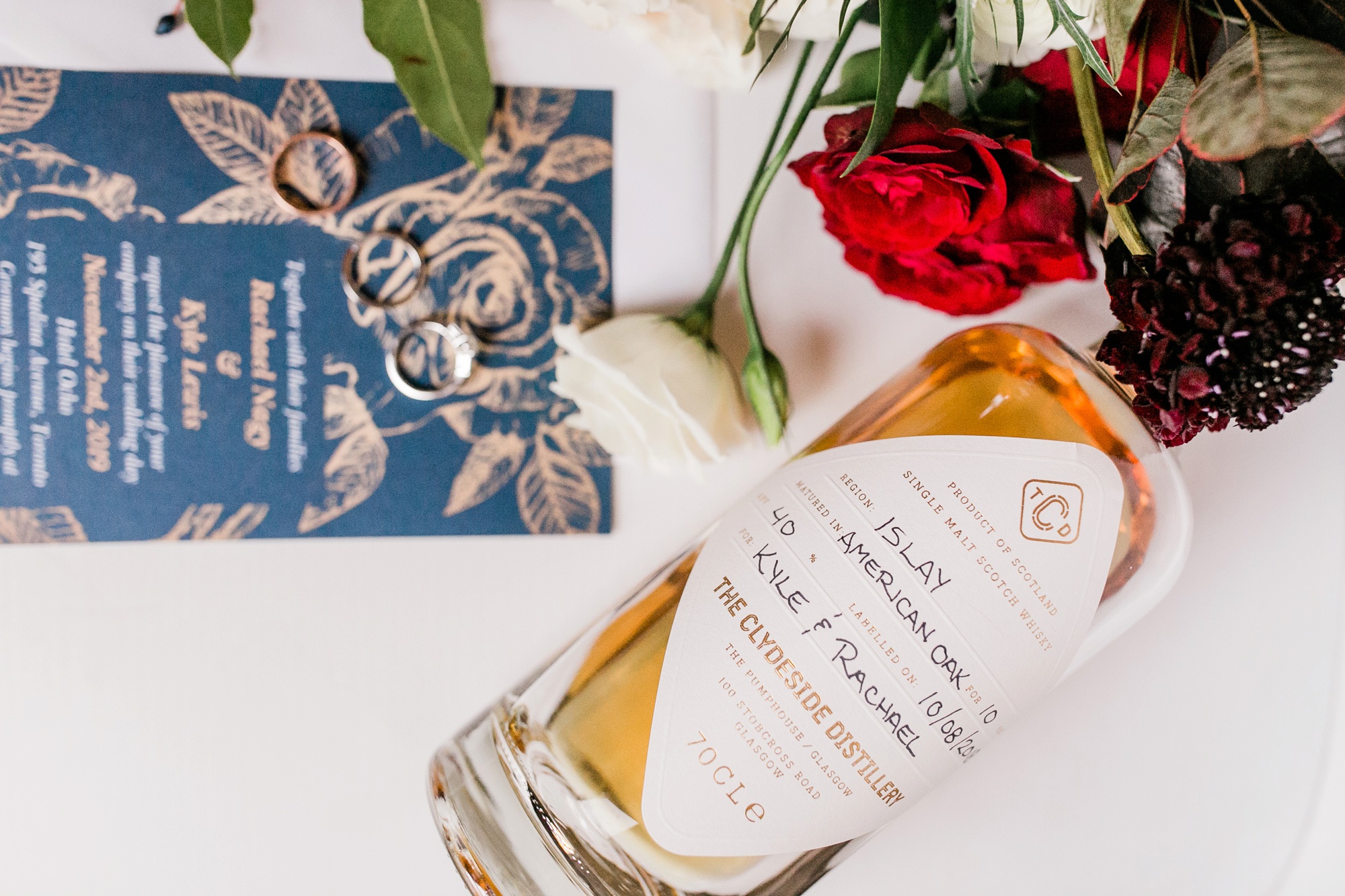 bottle of scotch with wedding invite