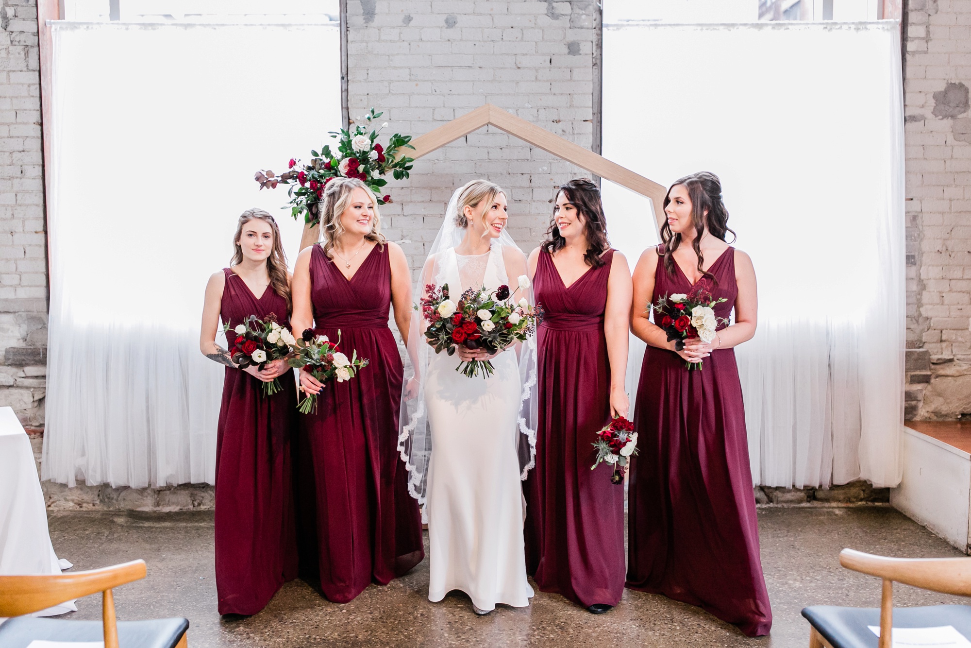 bridesmaids in merlot dresses and bride