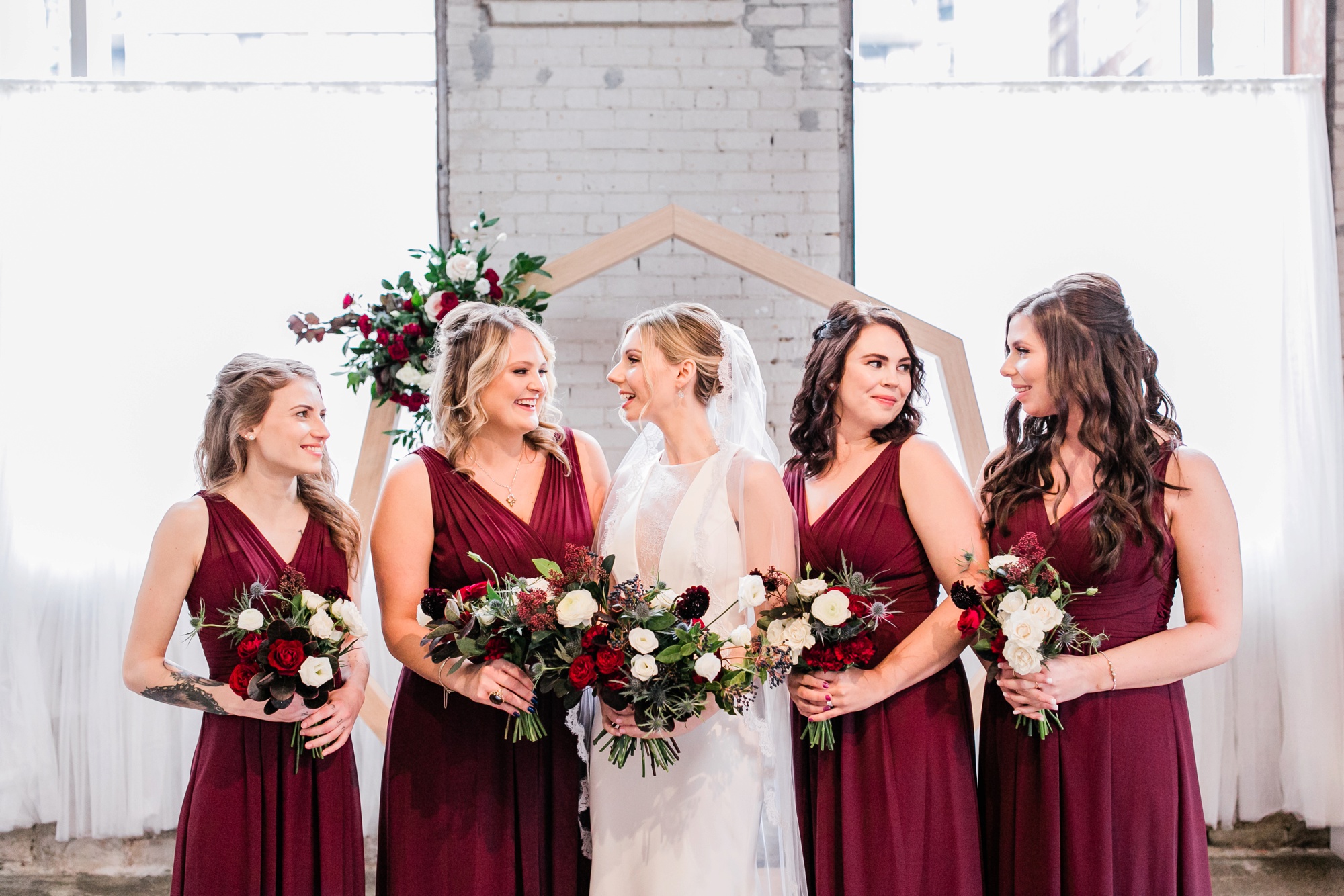 bridesmaids in merlot dresses and bride