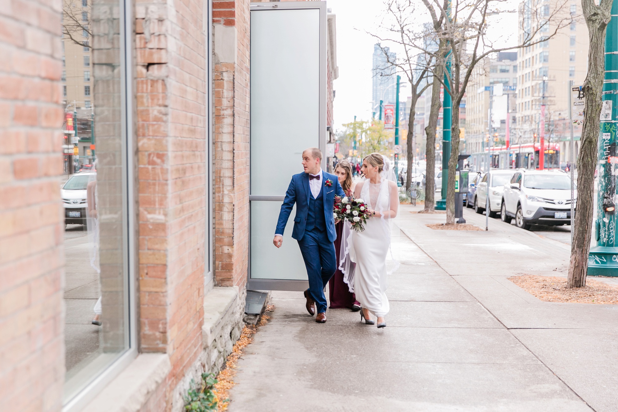 bride and groom walking out of building
