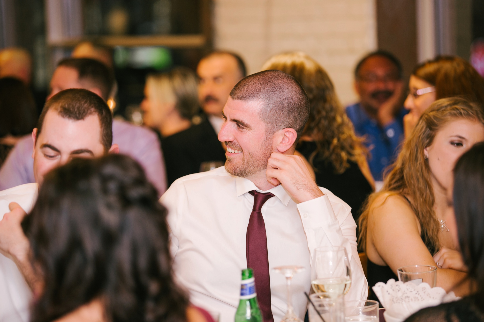 guests laughing during wedding speeches