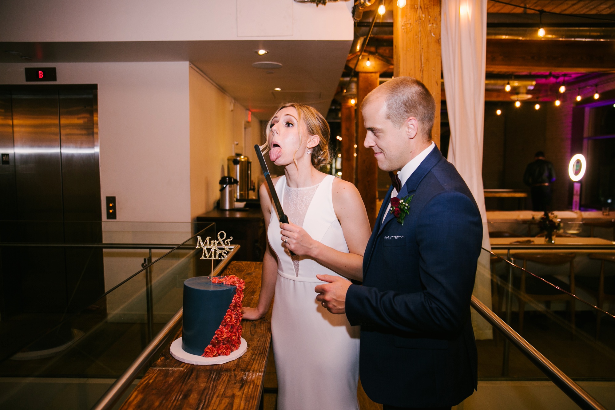 bride being funny cutting wedding cake